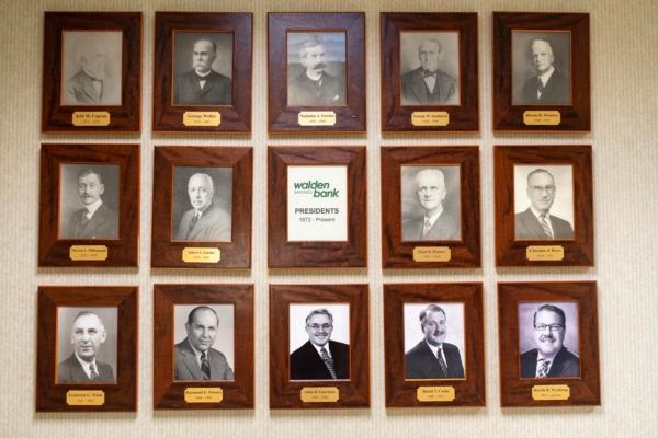 Photos of 14 presidents of Walden Savings Bank throughout its 150-year history, displayed at Walden Savings Bank in Montgomery, N.Y., on July 18, 2023. (Cara Ding/The Epoch Times)