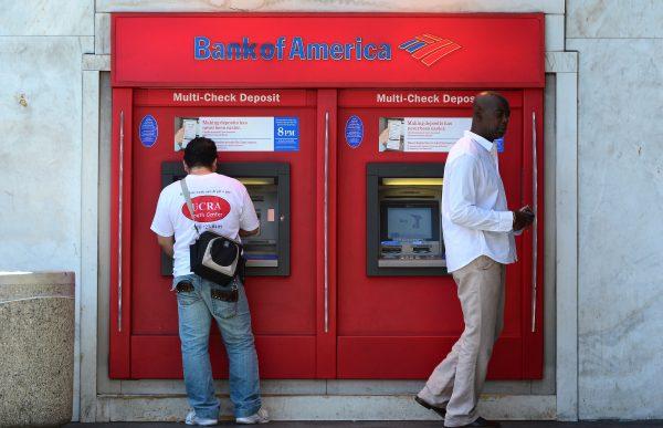 Bank customers use an ATM in Hollywood, Calif., on July 20, 2012. (Frederic J. Brown/AFP/GettyImages)