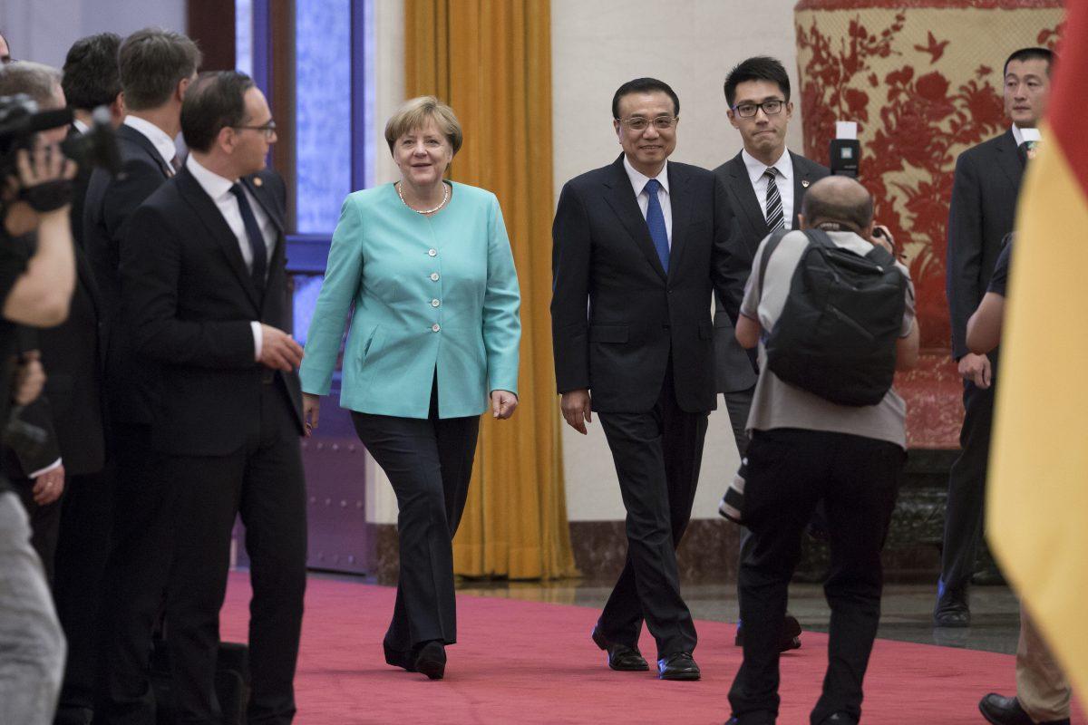 Germany's Chancellor Angela Merkel walks with China's Premier Li Keqiang as they arrive for a welcome ceremony at the Great Hall of the People in Beijing on June 13, 2016. (Andy Wong/AP Photo)