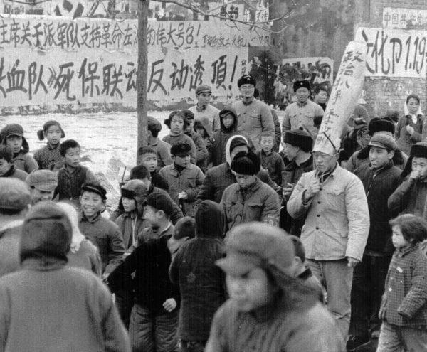 A Chinese official is paraded through the streets of Beijing by Red Guards on Jan. 25, 1967. The words on his hat accuse him of being a 'political pickpocket.' During Mao's reign (1949–1977), many Chinese citizens and officials were accused of political crimes, and labeled "class enemies" and "counter-revolutionaries." (AP Photo)