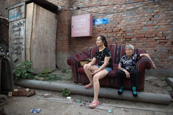 Women on a street in a migrant village on the outskirts of Beijing, on Sept. 7, 2017. (Nicolas Asfouri/AFP/Getty Images)
