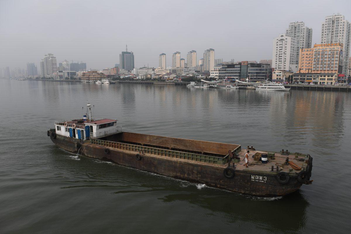 A North Korean ship passes in front of the waterfront of the Chinese border city of Dandong (at rear), in China's northeast Liaoning province, opposite the North Korean town of Sinuiju on Sept. 4, 2017. (GREG BAKER/AFP/Getty Images)