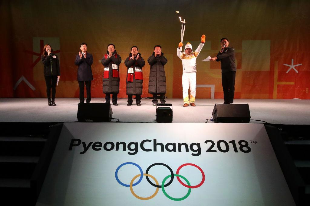 Torchbearer Yang Jung-Mo holds the PyeongChang 2018 Winter Olympics torch during the PyeongChang 2018 Winter Olympic Games torch relay on Nov. 4, 2017, in Busan, South Korea. (Chung Sung-Jun/Getty Images)