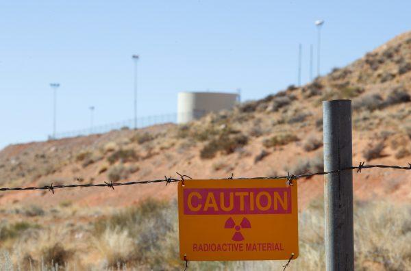 A radioactive warning sign hangs on fencing around the Anfield's Shootaring Canyon Uranium Mill on Oct. 27, 2017 outside Ticaboo, Utah. Anfield is in partnership with the Russian firm Uranium One, and bought the mill from Uranium One in 2015. (George Frey/Getty Images)