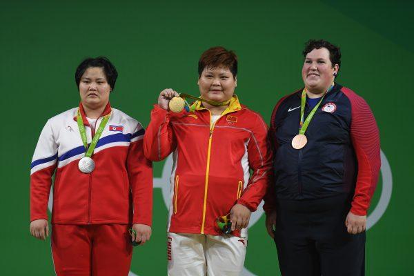 Kuk Hyang Kim (L) of North Korea, seemed shaken after she reached mere silver for the Weightlifting - Women's +75kg Group A at the Olympics in Rio de Janeiro, Brazil, on Aug. 14, 2016. (Laurence Griffiths/Getty Images)