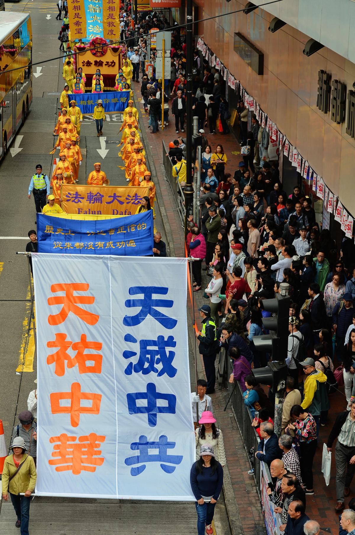 Parade participants hold a banner that reads, "the heavens will protect the land of China. The heavens will eliminate the Chinese Communist Party." (Song Bilong/The Epoch Times)