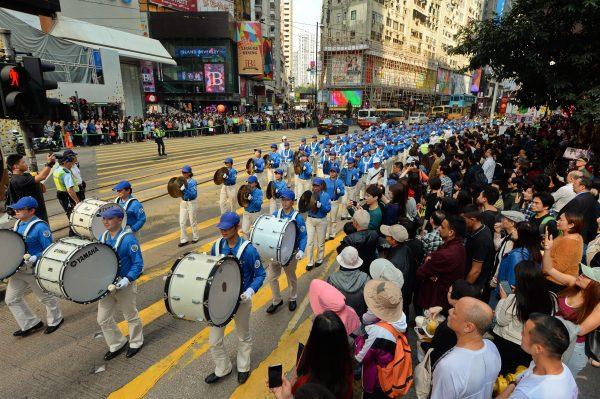 Falun Dafa practitioners in the Tianguo Marching Band participate in Hong Kong's parade to celebrating 300 million quitting the Chinese Communist Party, on March 18, 2018. (Song Bilong/The Epoch Times)