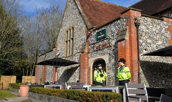 Police officers stand outside a pub near to where former Russian inteligence officer Sergei Skripal, and his daughter Yulia were found unconscious after they had been exposed to an unknown substance, in Salisbury on March 7, 2018. (Reuters/Toby Melville)