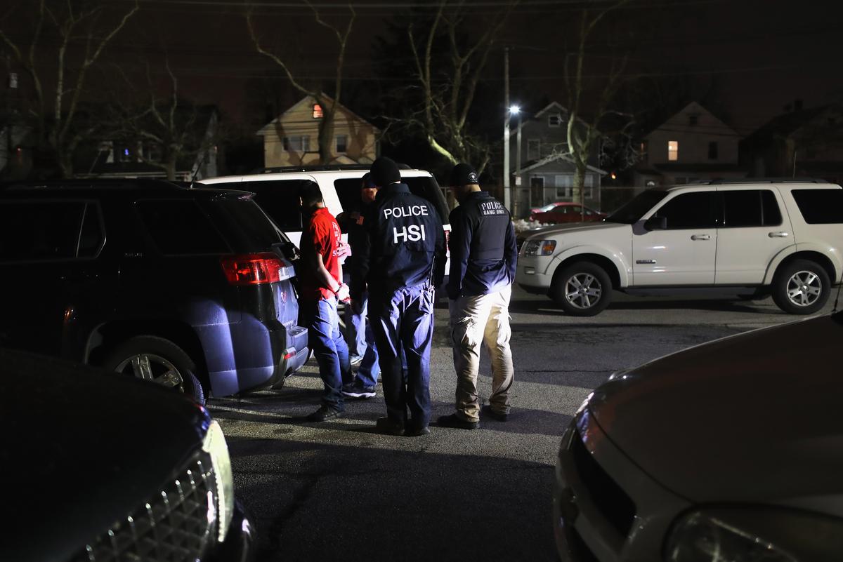 Federal agents arrest a suspected gang member in Hempstead, N.Y., late on March 28. The actions were part of Operation Matador, a nearly yearlong anti-gang effort targeting transnational gangs, with an emphasis on MS-13. (John Moore/Getty Images)