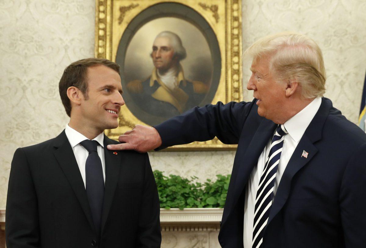 French President Emmanuel Macron (L) looks on as President Donald Trump gestures toward him during their meeting in the Oval Office following the official arrival ceremony for Macron at the White House in Washington on April 24, 2018. (REUTERS/Kevin Lamarque)