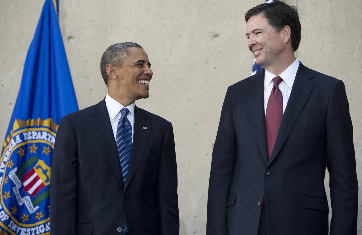 President Barack Obama speaks with new FBI Director James Comey (R) during an installation ceremony at Federal Bureau of Investigation Headquarters in Washington, DC, October 28, 2013. (SAUL LOEB/AFP/Getty Images)