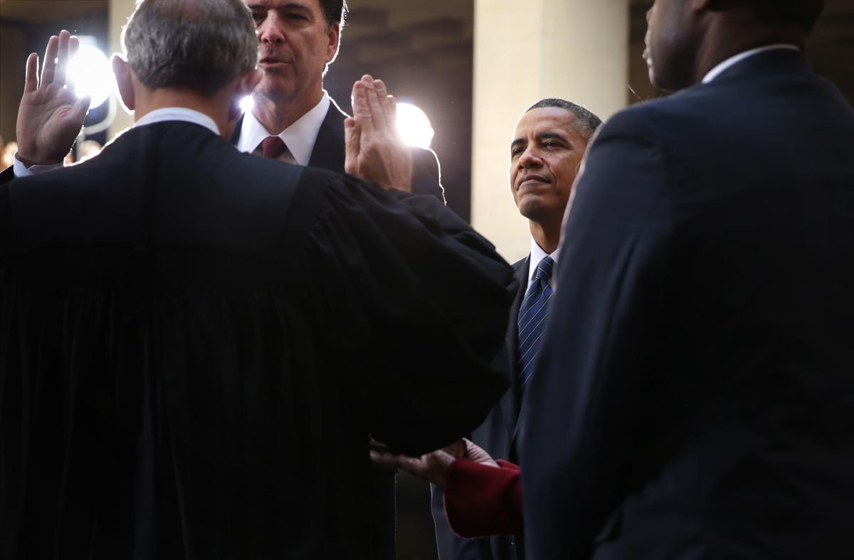 FBI Director James Comey (2nd L) participates in a ceremonial swearing-in, officiated by Judge John Walker (L), as U.S. President Barack Obama (3rd L) looks on at the FBI Headquarters October 28, 2013 in Washington, DC. (Alex Wong/Getty Images)