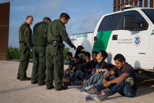 Border Patrol agents apprehend illegal immigrants shortly after they crossed the border from Mexico into the United States in the Rio Grande Valley Sector near McAllen, Texas, on March 26, 2018. (LOREN ELLIOTT/AFP/Getty Images)