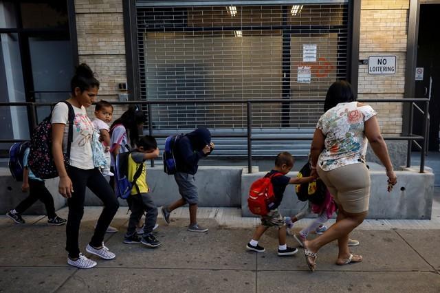 Children cover their faces as they are escorted to the Cayuga Center, which provides foster care and other services to immigrant children separated from their families, in New York City, July 10, 2018. (Brendan McDermid/Reuters)