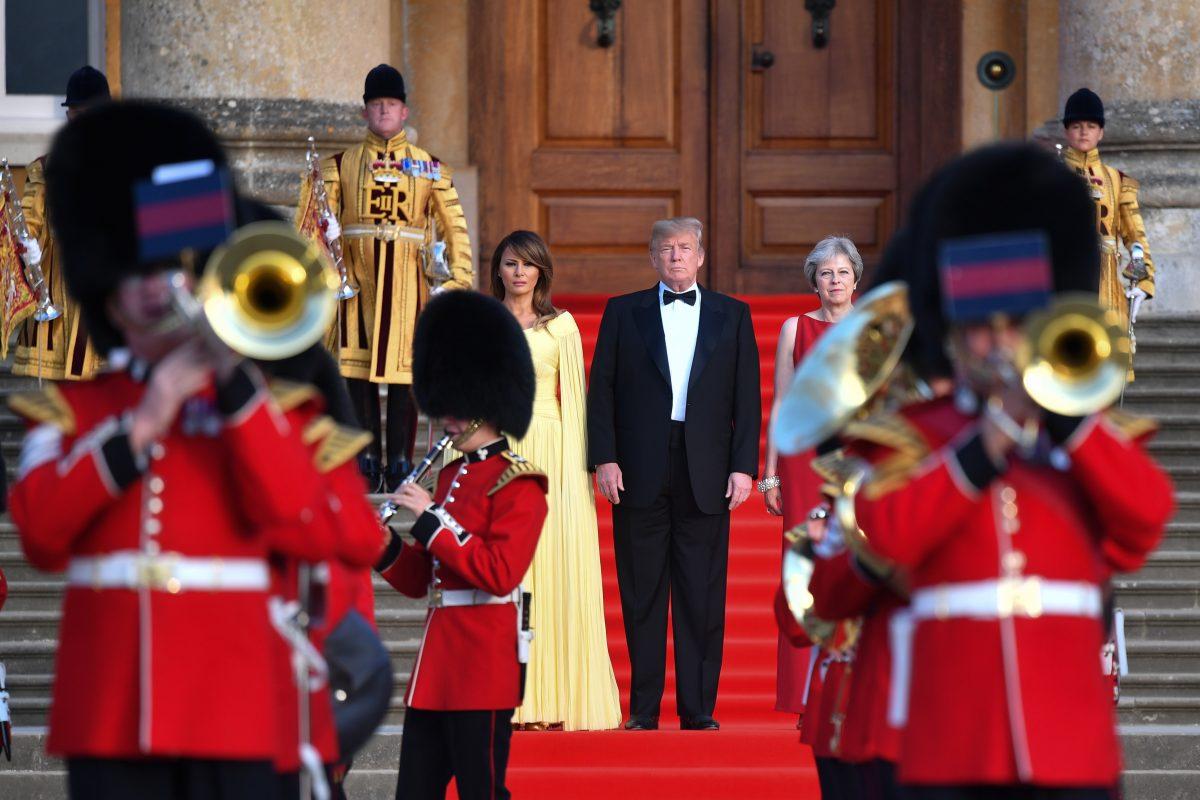 (R-L) Britain Prime Minister Theresa May, President Donald Trump, and First Lady Melania Trump watch a military band play at Blenheim Palace in Woodstock, England, on July 12, 2018. (Ben Stansall - WPA Pool/Getty Images)