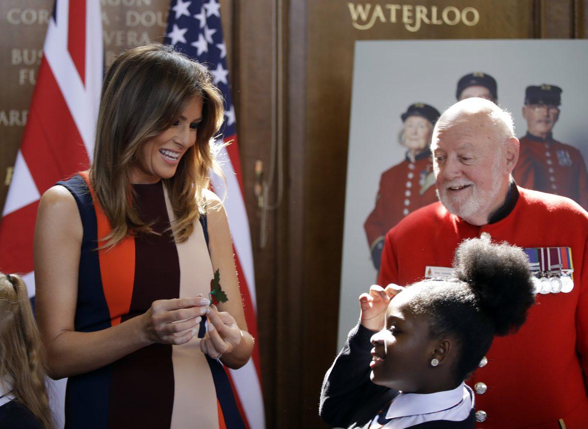 First Lady Melania Trump helps children to make poppies during a visit with British military veterans at Royal Hospital Chelsea in London on July 13, 2018. (Luca Bruno–WPA Pool/Getty Images)
