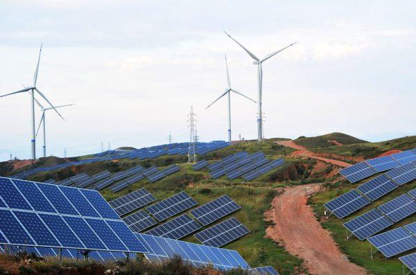 Solar panels and wind turbines on a barren mountain at Shenjing Village in Zhangjiakou, Hebei Province, on July 2, 2018. (VCG)