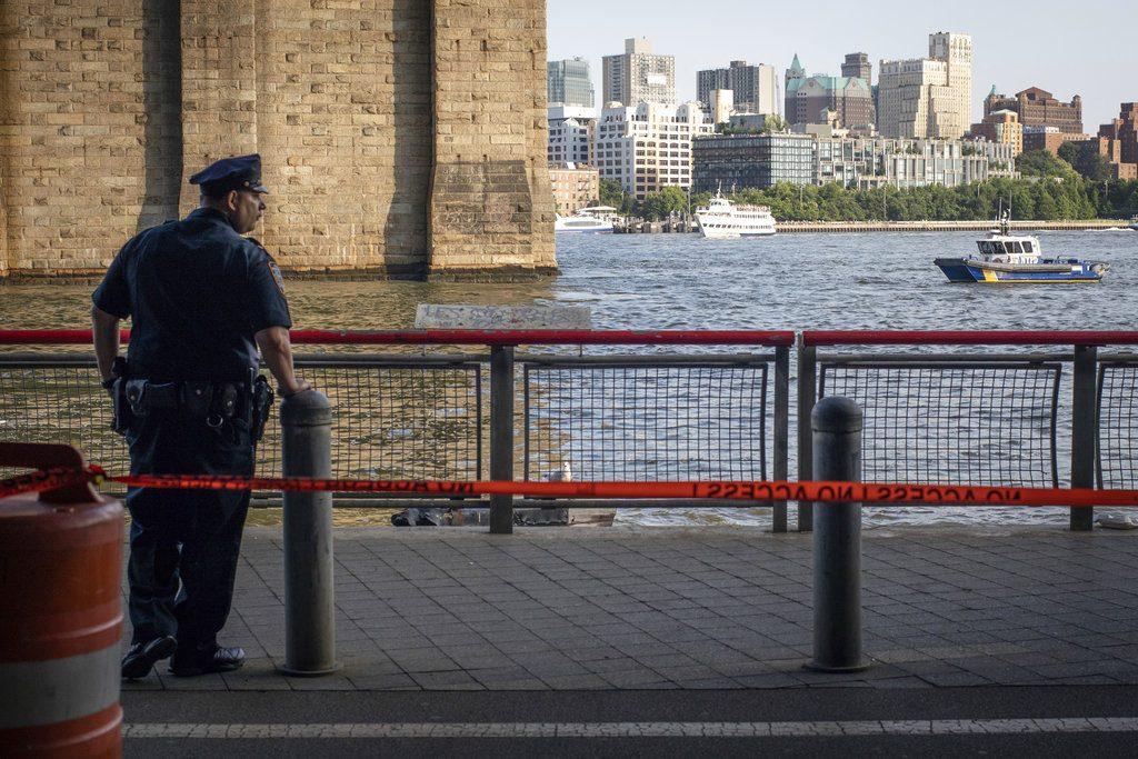 A New York Police Department officer stands guard as authorities investigate the death of a baby boy who was found floating in the East River near the Brooklyn Bridge in the Manhattan borough of New York on Aug. 5, 2018. (AP Photo/Robert Bumsted, File)