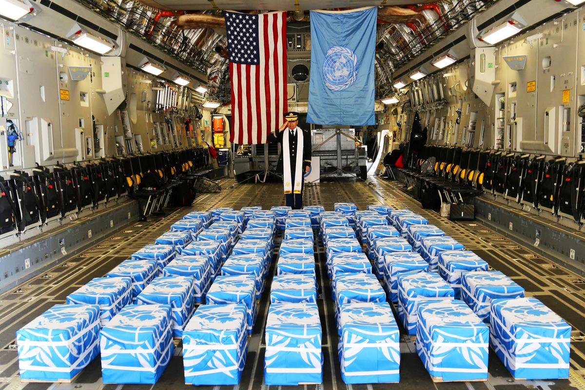 United Nations Command Chaplain U.S. Army Col. Sam Lee performs a blessing of sacrifice and remembrance on the 55 boxes of remains thought to be of U.S. soldiers killed in the 1950-53 Korean War, returned by North Korea to the U.S., at the Osan Air Base in South Korea, July 27. (U.S. Army/ Sgt. Quince Lanford/via Reuters)