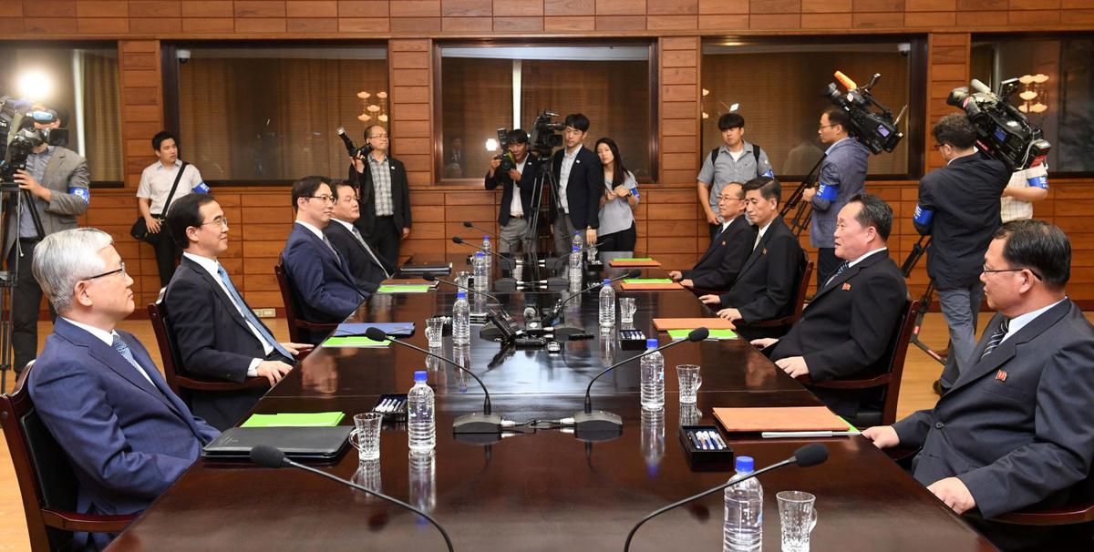 South Korean Unification Minister Cho Myoung-gyon talks with his North Korean counterpart Ri Son Gwon during their meeting at the truce village of Panmunjom inside the demilitarized zone, North Korea, Aug. 13, 2018. (Yonhap via Reuters)