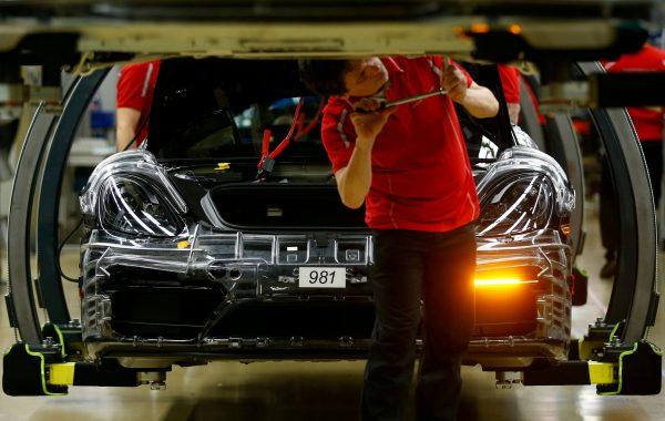 FILE PHOTO: An employee of German car manufacturer Porsche works at the Porsche factory in Stuttgart-Zuffenhausen, Germany, Jan. 26, 2018. (Ralph Orlowski/Reuters/File Photo)