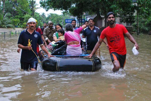 Indian volunteers and rescue personnel evacuate local residents in a boat in a residential area at Kozhikode, in the Indian state of Kerala, on Aug. 16, 2018. (AFP/Getty Images)