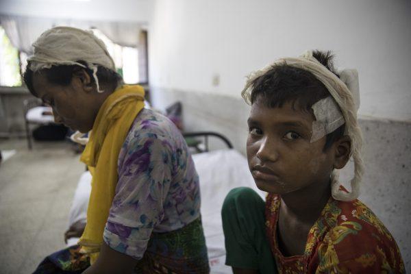 Rohingya refugee Dildar Begum, 30, recovers from her wounds alongside her 10-year-old child at the Sadar city hospital on Sept. 15, 2017, in Cox's Bazar, Bangladesh. (Paula Bronstein/Getty Images)