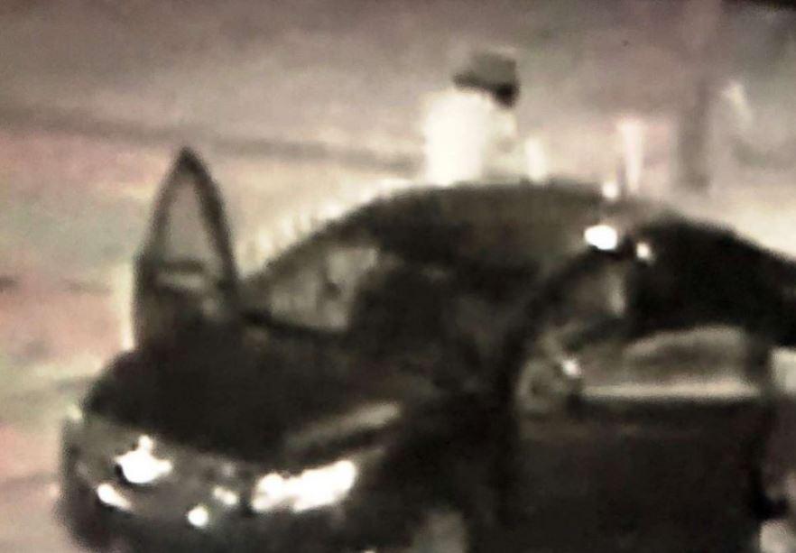 A grainy surveillance image shows a vehicle and a shooting suspect in the parking lot of The Cobra in the early hours of Friday, Aug. 17, 2018, in Nashville, Tenn. (Nashville Police Department)