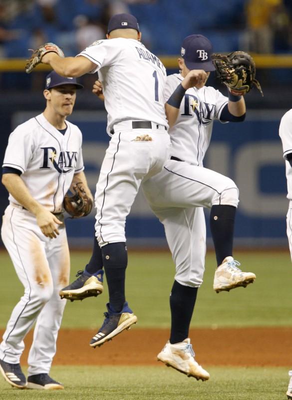 Tampa Bay Rays shortstop Willy Adames (1) and first baseman Jake Bauers (9) celebrate as second baseman Joey Wendle (left) looks on following their win over the Kansas City Royals. (Reinhold Matay/USA Today Sports)