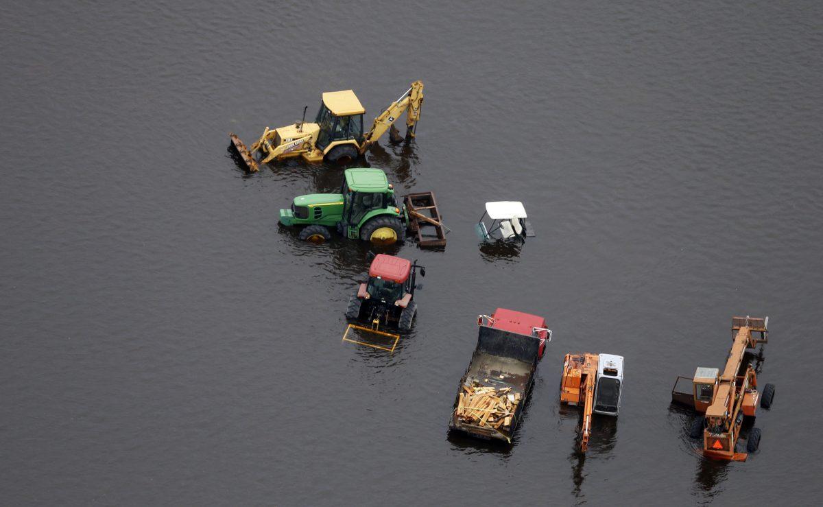 Farm equipment is positioned in a flooded field near Trenton, N.C., Sept. 16, 2018. (Steve Helber/AP Photo)