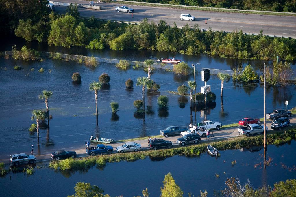 People use a road as a boat ramp after Hurricane Florence struck the Carolinas on Sept. 17, 2018, in Conway, S.C. (AP Photo/Sean Rayford)