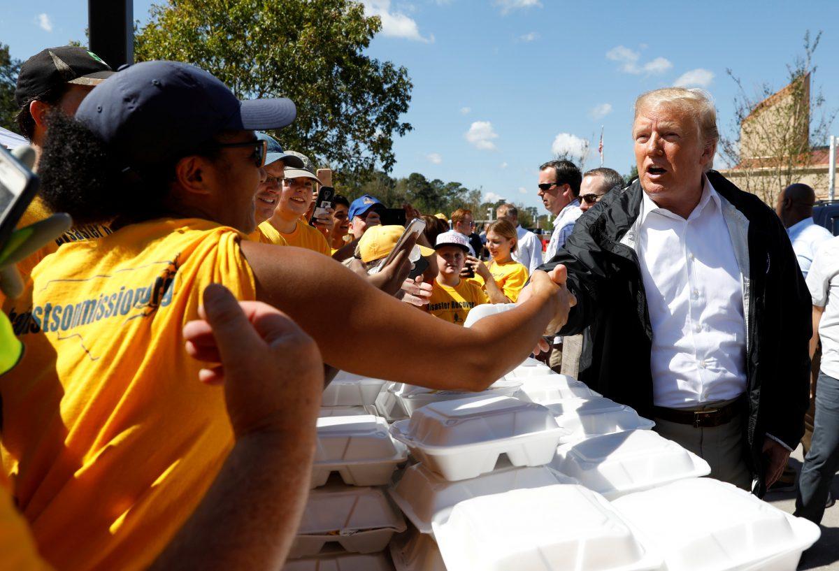 President Donald Trump greets people while distributing food after Hurricane Florence in New Bern, N.C., Sept. 19, 2018. (Kevin Lamarque/Reuters)
