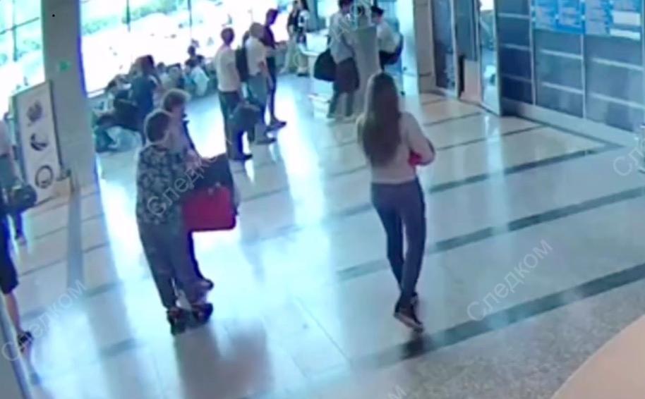 The young mother's companion makes contact with the woman who will take the baby. (Screengrab via Investigative Committee of the Russian Federation)