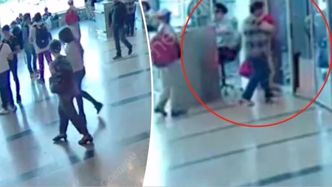 The young mother walks away with her companion, as the St. Petersburg teacher walks off with her baby. (Screengrab via Investigative Committee of the Russian Federation)