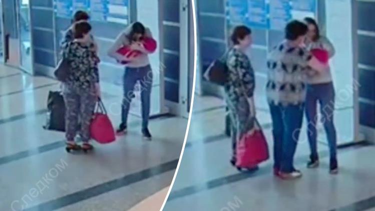 The young mother leans in as if to say a final goodbye before handing over her baby to a complete stranger she met online. (Screengrab via Investigative Committee of the Russian Federation)