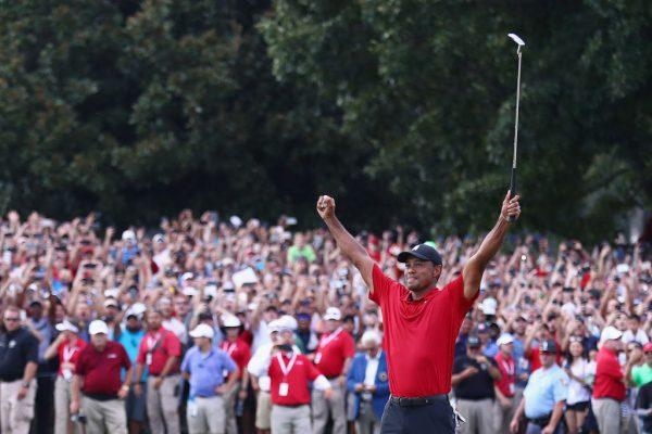 Tiger Woods celebrates making a par on the 18th green to win the Tour Championship at East Lake Golf Club on Sept. 23, 2018, in Atlanta. (Tim Bradbury/Getty Images)