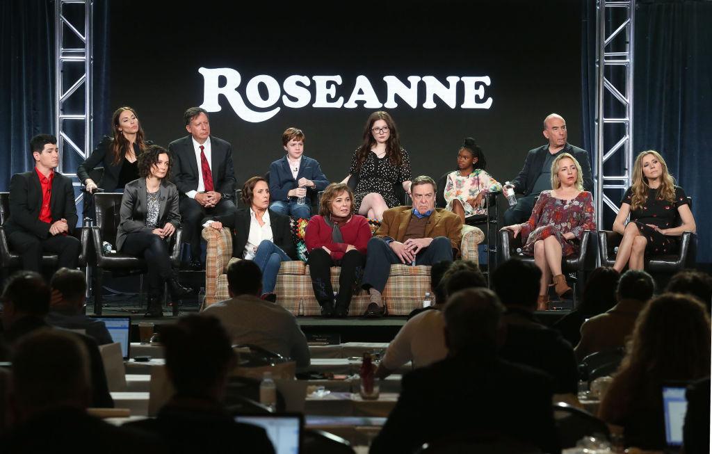 (L-R, Back Row) Executive producers Whitney Cummings and Tom Werner, actors Ames McNamera, Emma Kenney, Jayden Rey, executive producer Bruce Helford, (l-r, front row) actor Michael Fishman, executive producer/actress Sara Gilbert, actress Laurie Metcalf, executive producer/actress Roseanne Barr, actors John Goodman, Lecy Goranson and Sarah Chalke of the television show 'Roseanne' speak onstage during the ABC Television/Disney portion of the 2018 Winter Television Critics Association Press Tour at The Langham Huntington, Pasadena in Pasadena, California on Jan. 8, 2018. (Photo by Frederick M. Brown/Getty Images)