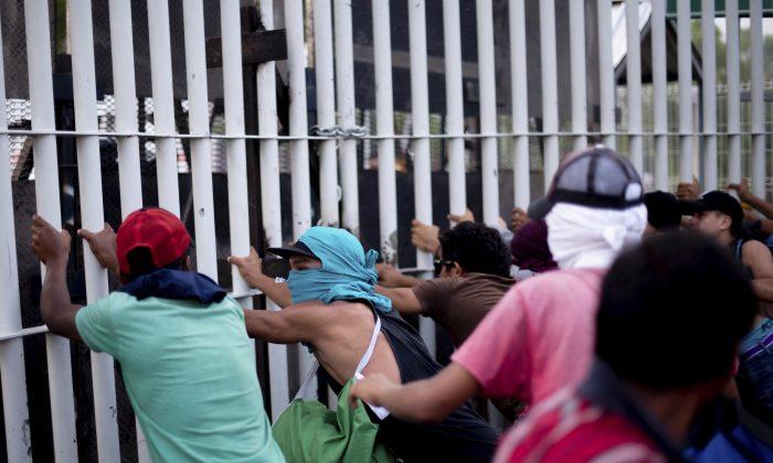 Video: Migrants Breach Border Fence, Throw Rocks, Are Repelled by Border Patrol