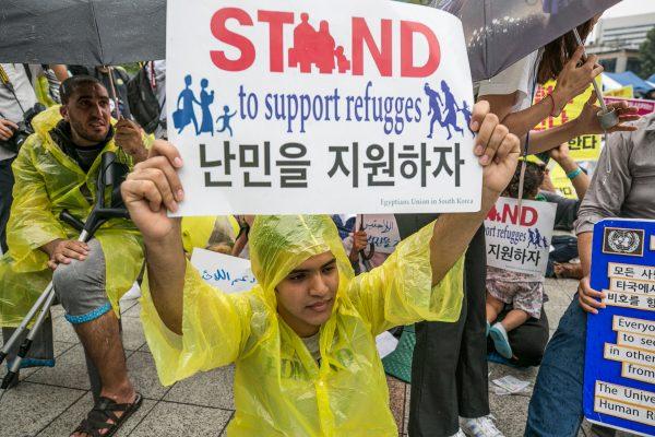 Activists hold signs in support of Yemeni asylum seekers in South Korea on Sept. 16, 2018 in Seoul. (Jean Chung/Getty Images)