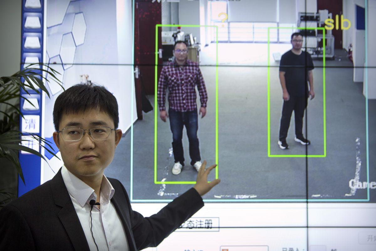Huang Yongzhen, CEO of Watrix, demonstrates his company's gait recognition software at its offices in Beijing on Oct. 31, 2018. The startup hopes to begin selling software that recognizes people by their body shape and how they walk, enabling identification when faces are hidden. Already used by police on the streets of Beijing and Shanghai, the technology is raising concerns about how far surveillance will go. (Mark Schiefelbein/AP)