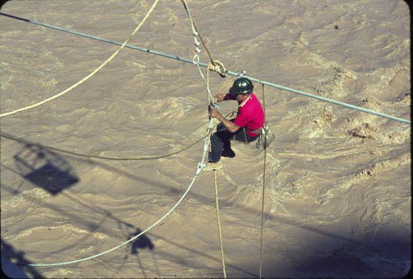 Contractor's technician attaching cables for lateral bracing of the Silver Bridge above the Colorado River. Circa 1965. (NPS)