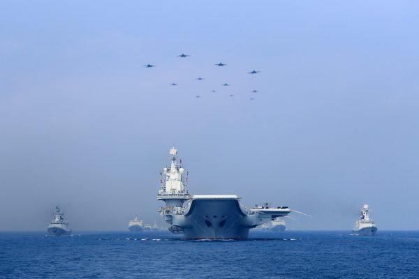 Warships and fighter jets of Chinese People's Liberation Army Navy (PLAN) take part in a military display in the South China Sea on April 12, 2018. (Reuters)