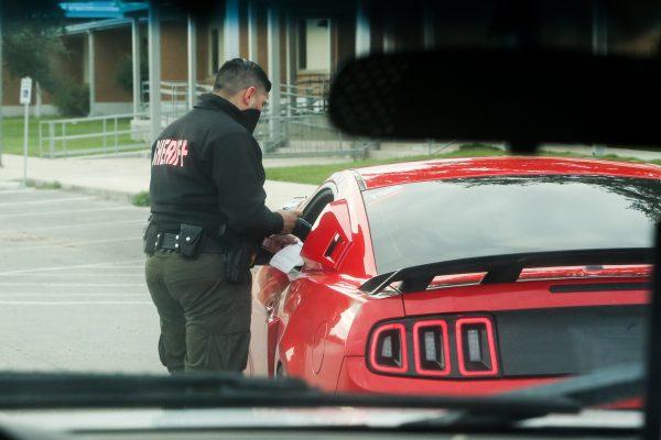 Sheriff's Deputy Luis Flores stops a car for a traffic violation in Refugio County in Texas on Nov. 10, 2018. He discovered the car had not been registered since April 2016. Samira Bouaou/The Epoch Times