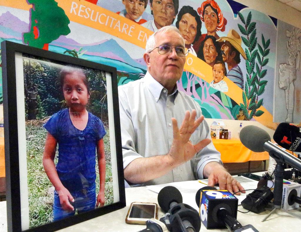 Annunciation House director Ruben Garcia answers questions from the media after reading a statement from the family of Jakelin Maquin, pictured at left, during a press briefing at Casa Vides in downtown El Paso, Texas Dec. 15, 2018. (Rudy Gutierrez/The El Paso Times via AP)