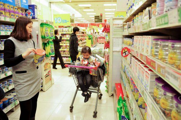 A Chinese customer selects milk powder at a supermarket in Qingdao, east China's Shandong province on February 14, 2017. (STR/AFP/Getty Images)