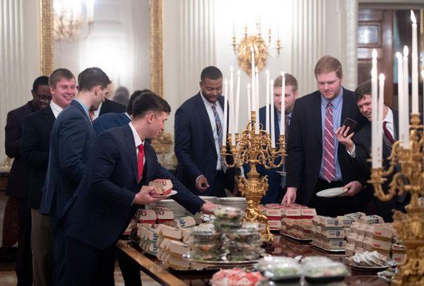 Guests select fast food that the president purchased for a ceremony honoring the 2018 College Football Playoff National Champion Clemson Tigers in the State Dining Room of the White House in Washington, on Jan. 14, 2019. (Saul Loeb/AFP/Getty Images)