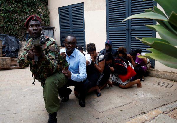 People are evacuated by a member of security forces at the scene where explosions and gunshots were heard at the Dusit hotel compound, in Nairobi, Kenya, on Jan. 15, 2019. (Baz Ratner/Reuters)