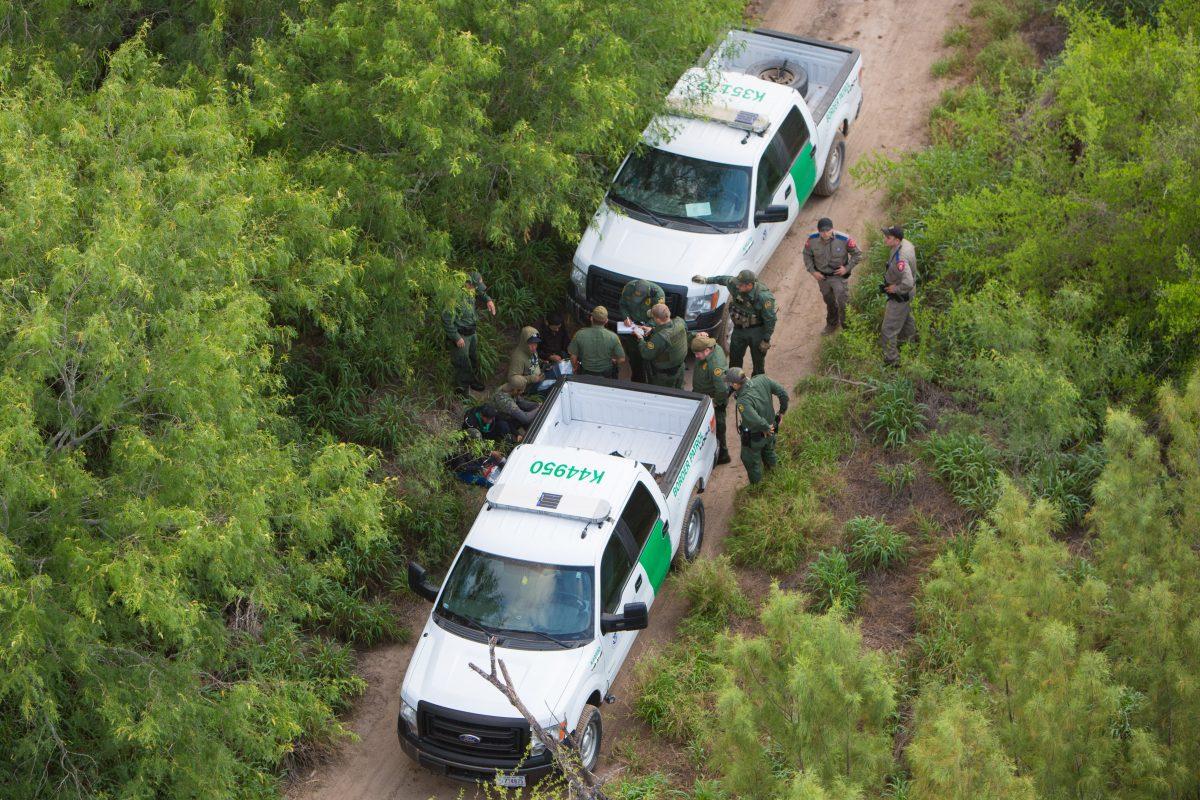 A view from a Customs and Border Protection helicopter, shows the Texas Border Patrol and Texas State Troopers detaining aliens who were trying to remain hidden after they came over to the United States from Mexico in the Texas area near Hidalgo, Texas, on May 30, 2017. (Benjamin Chasteen/The Epoch Times)