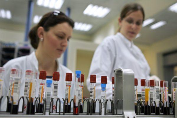 File photo showing laboratory technicians supervising as vials of human blood are processed on an automated testing line at a laboratory in Nes Tsiona, Israel, on Jan. 22, 2006. (David Silverman/Getty Images)