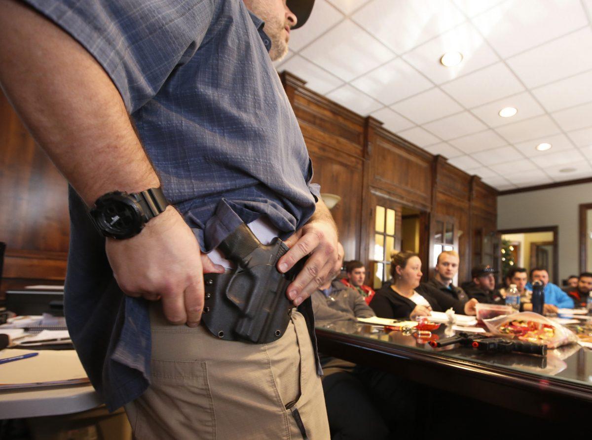 Damon Thueson shows a holster at a gun concealed carry permit class put on by "USA Firearms Training" in Provo, Utah, on Dec. 19, 2015. (George Frey/Getty Images)